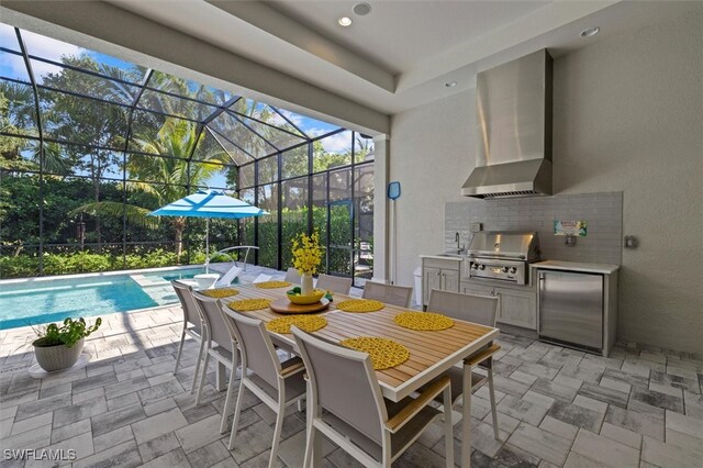 view of patio / terrace with glass enclosure, exterior kitchen, sink, and grilling area