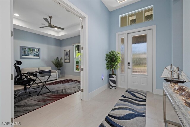 entrance foyer with ceiling fan and light tile patterned flooring