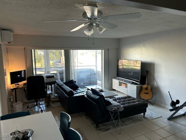 tiled living room featuring a wall unit AC, a textured ceiling, plenty of natural light, and ceiling fan