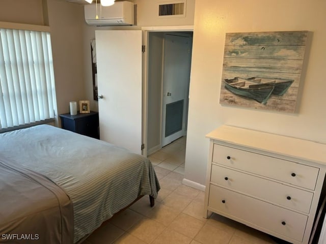 tiled bedroom featuring an AC wall unit