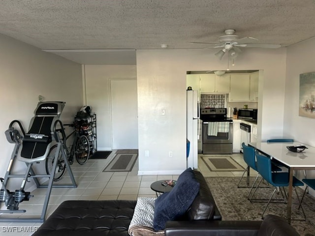 kitchen featuring appliances with stainless steel finishes, a textured ceiling, white cabinets, and ceiling fan