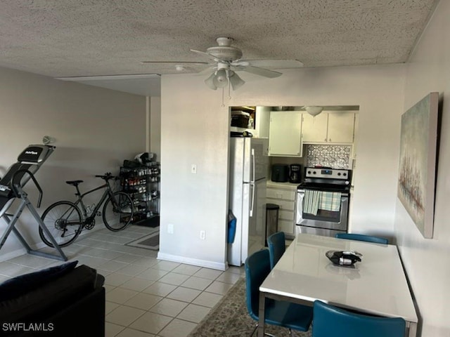 2350 W 1st St Unit 205, Fort Myers, FL 33901 - kitchen featuring stainless steel range with electric stovetop, freestanding refrigerator, tile patterned floors, and a ceiling fan