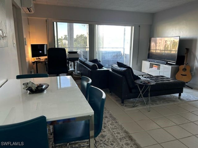2350 W 1st St Unit 205, Fort Myers, FL 33901 - dining area with an AC wall unit, tile patterned flooring, and a textured ceiling