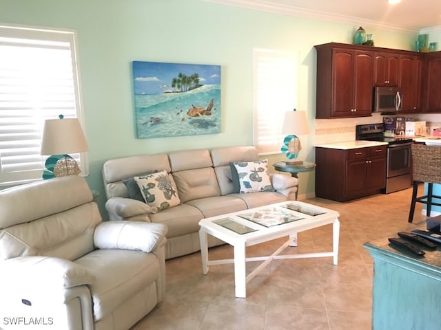 living room featuring ornamental molding and light tile patterned flooring