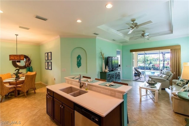 kitchen featuring dishwasher, a kitchen island with sink, dark brown cabinets, sink, and ceiling fan