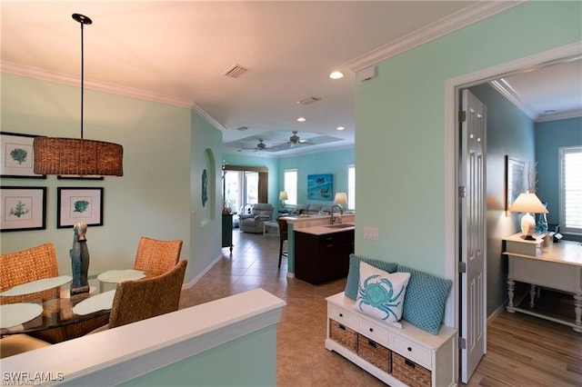 hall with sink, crown molding, and light hardwood / wood-style flooring