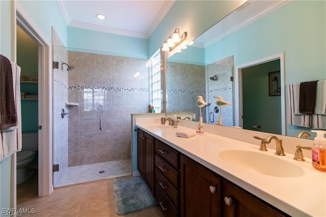 bathroom featuring an enclosed shower, toilet, vanity, ornamental molding, and tile patterned flooring