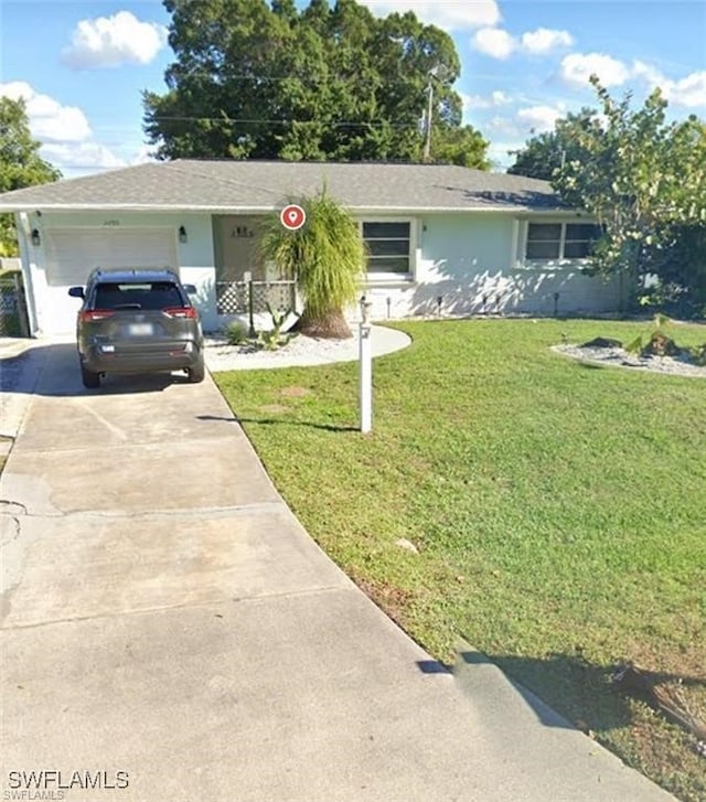 ranch-style home featuring a front yard and a garage