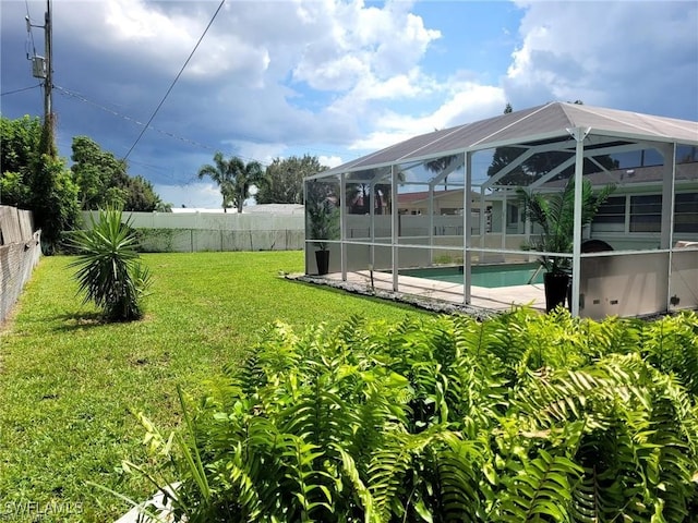 view of yard featuring a lanai and a fenced in pool