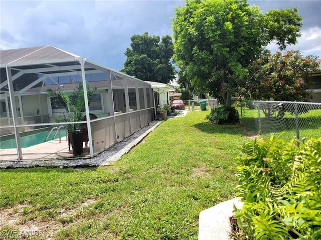 view of yard featuring a fenced in pool, a lanai, and a patio