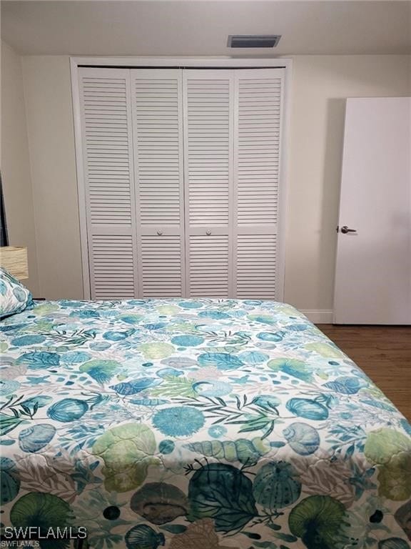 bedroom featuring hardwood / wood-style flooring and a closet