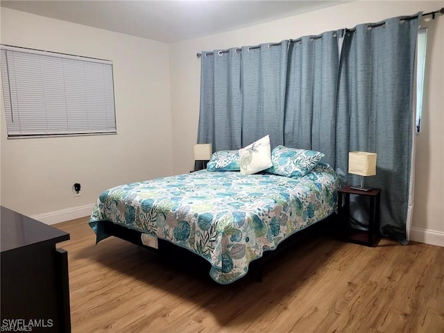 bedroom with hardwood / wood-style flooring