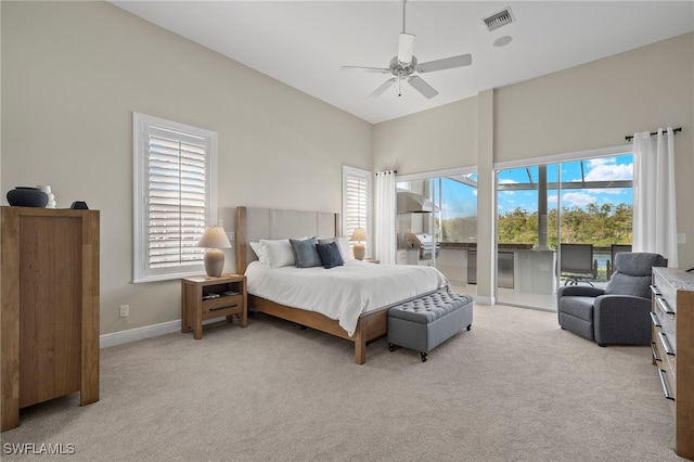 carpeted bedroom with ceiling fan, access to outside, and multiple windows