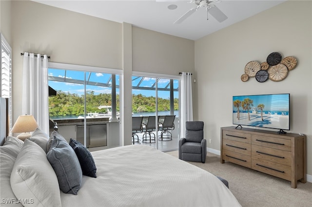 bedroom with light colored carpet, multiple windows, and ceiling fan