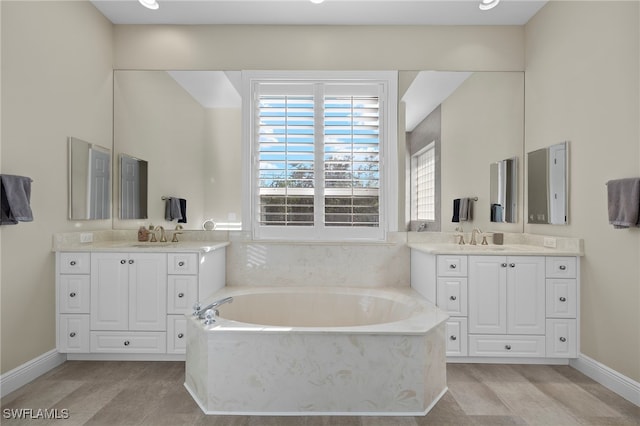 bathroom featuring a bathing tub, vanity, and hardwood / wood-style flooring