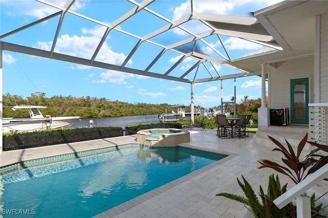 view of pool featuring a patio area, a lanai, an in ground hot tub, and a water view