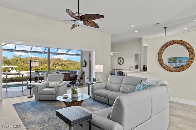 living room featuring light hardwood / wood-style floors and ceiling fan