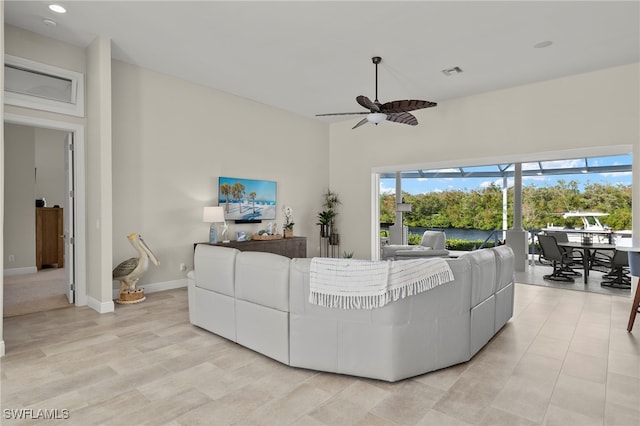 living room featuring ceiling fan and a healthy amount of sunlight