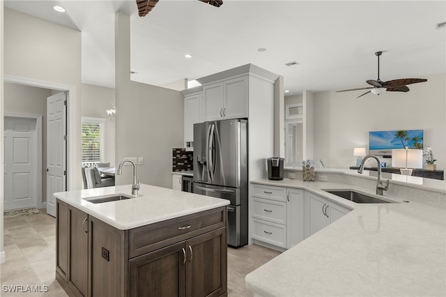 kitchen featuring white cabinets, stainless steel fridge with ice dispenser, dark brown cabinets, and sink