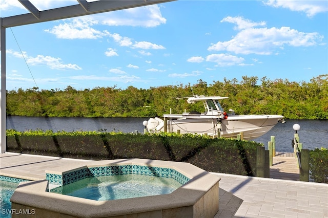 view of swimming pool featuring an in ground hot tub, a water view, and a dock