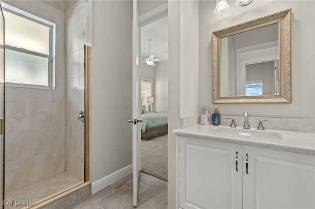 bathroom with tile patterned flooring, vanity, ceiling fan, and a shower with shower door