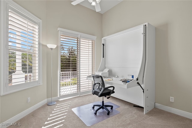 carpeted office with ceiling fan