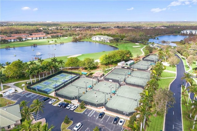 aerial view with golf course view and a water view