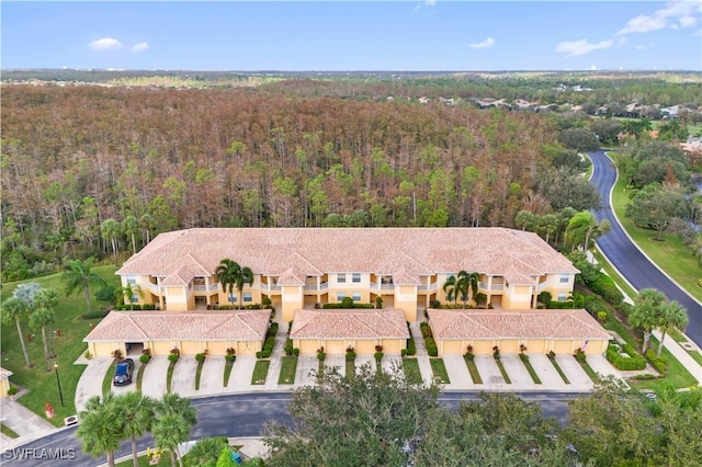 birds eye view of property with a view of trees