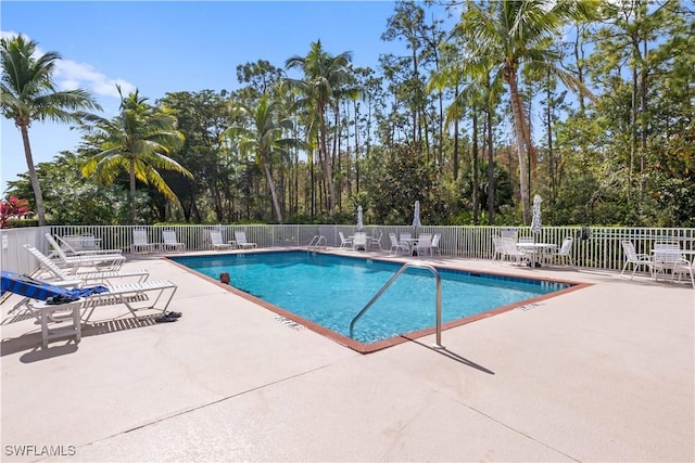 pool featuring a patio and fence