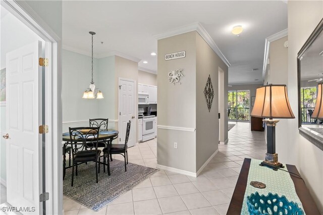 interior space featuring ornamental molding, an inviting chandelier, and light tile patterned floors