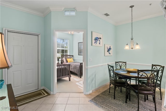 tiled dining room with crown molding and a chandelier