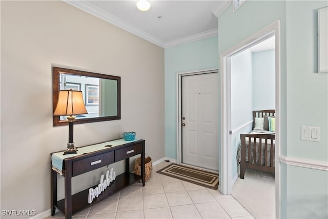 foyer entrance with light tile patterned floors, baseboards, and ornamental molding