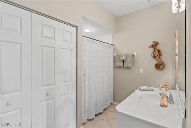 bathroom featuring a closet, vanity, and tile patterned flooring