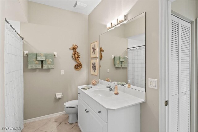 bathroom with vanity, toilet, and tile patterned floors