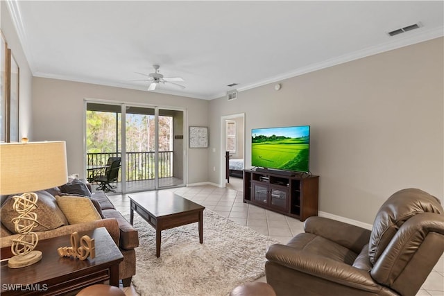 living area with light tile patterned floors, visible vents, baseboards, and ornamental molding