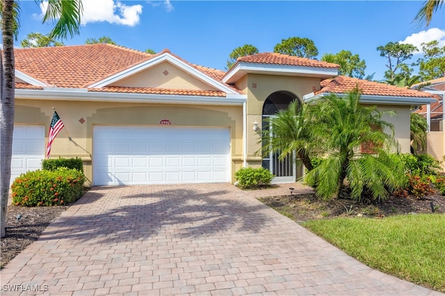 mediterranean / spanish house featuring a garage