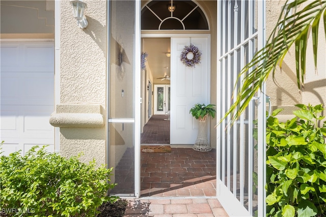 view of exterior entry with a garage