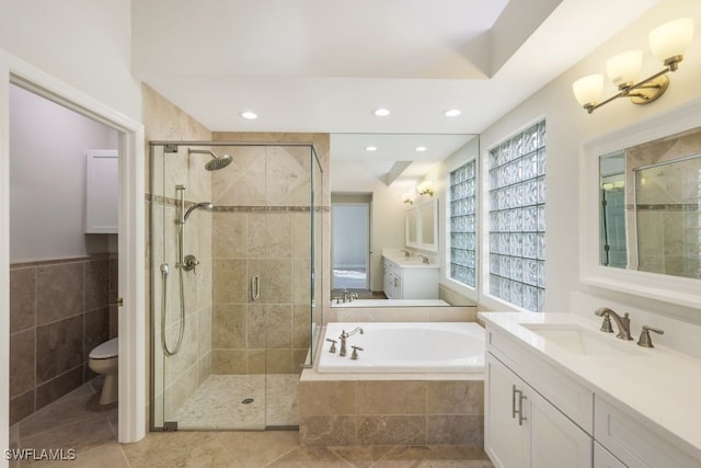 full bathroom with tile patterned flooring, vanity, toilet, and plus walk in shower