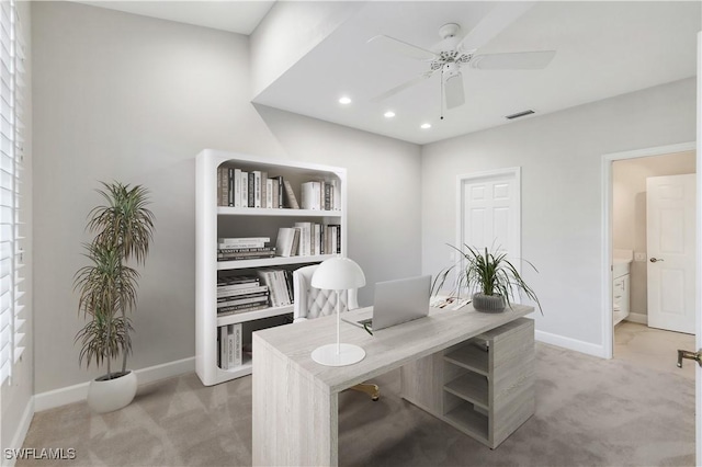 office space with ceiling fan and carpet