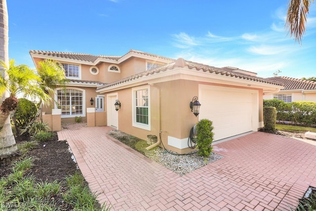 mediterranean / spanish home featuring a garage