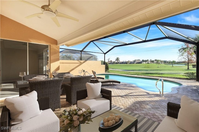 pool featuring ceiling fan, outdoor dining space, a lanai, and a patio area