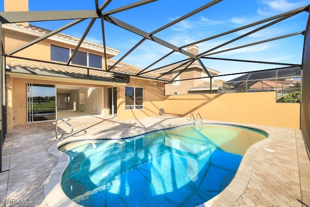 view of pool with a lanai and a patio area