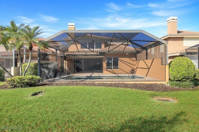 rear view of property featuring a lanai, a yard, and a patio