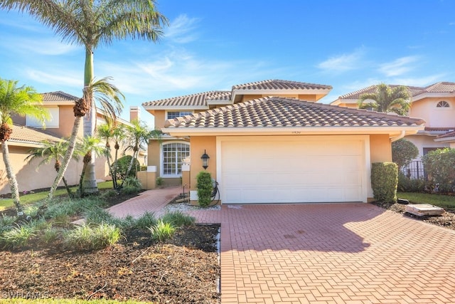 mediterranean / spanish home with a garage