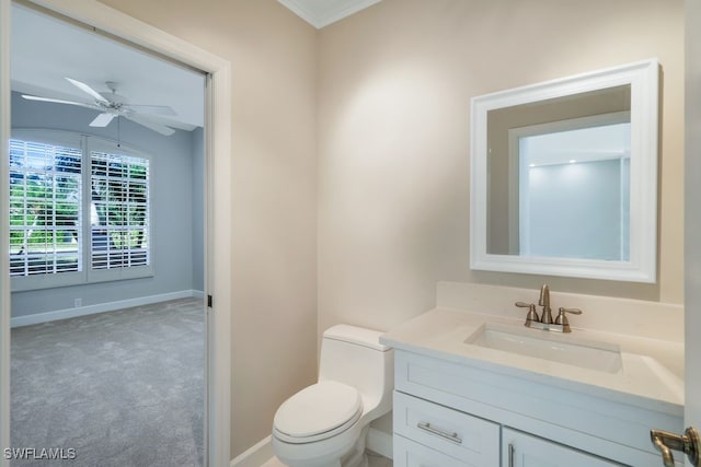 bathroom with vanity, ceiling fan, toilet, and crown molding