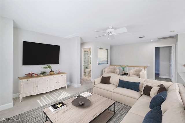 carpeted living room featuring ceiling fan