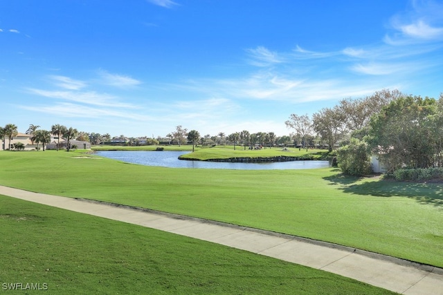 view of property's community with a water view and a yard