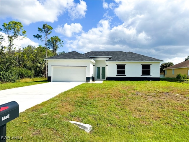 view of front of home with a front lawn, a garage, and french doors