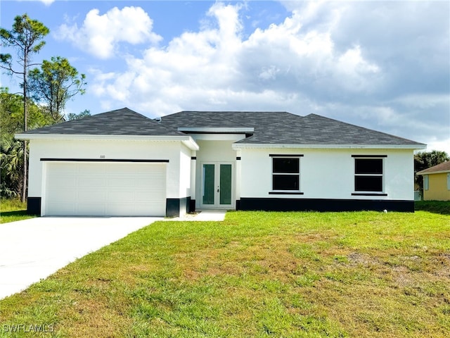 view of front facade featuring a garage, a front yard, and french doors