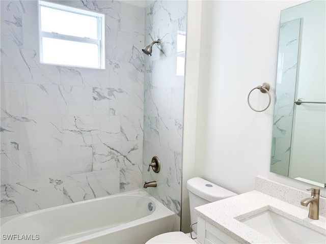 full bathroom with vanity, tiled shower / bath, and toilet